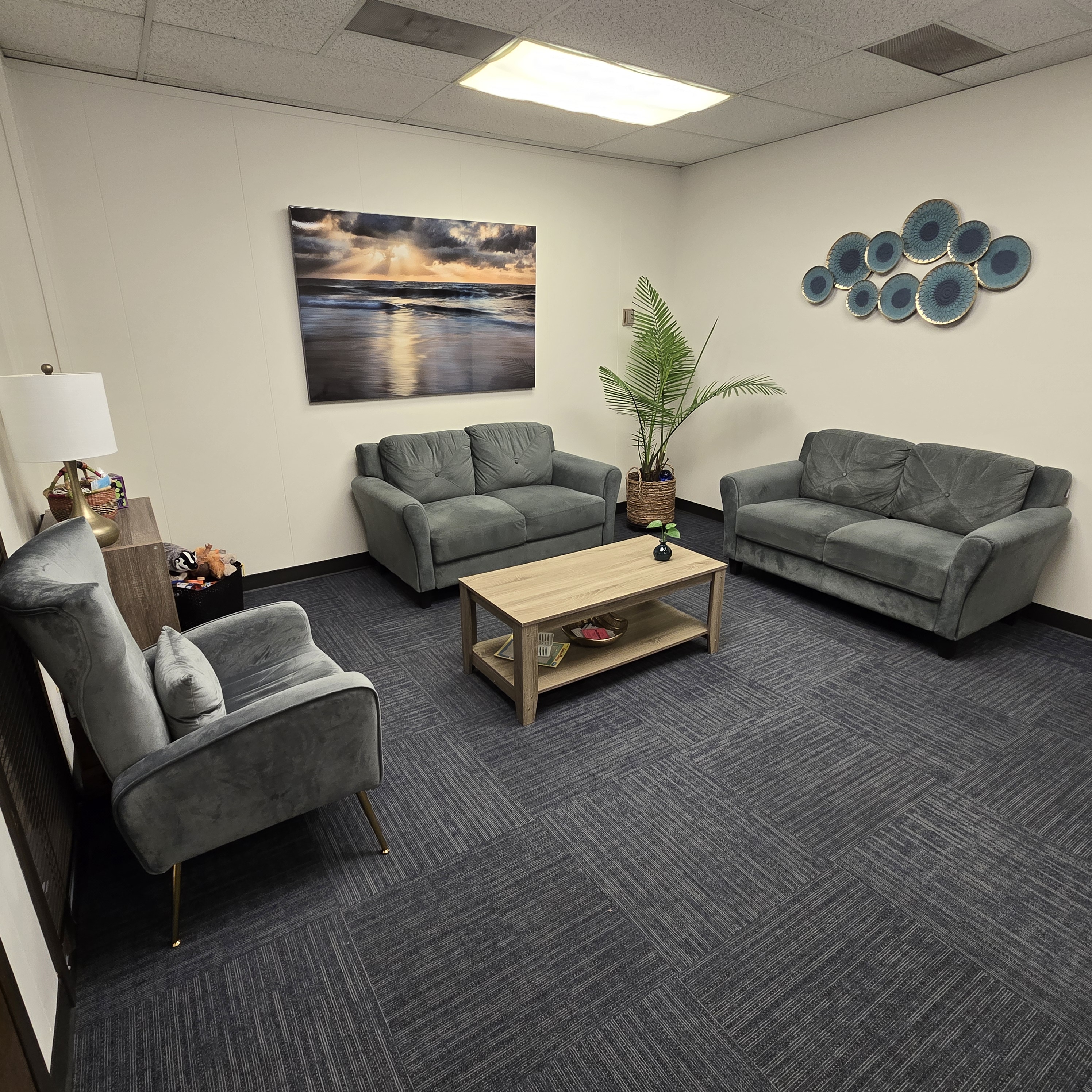 This photo shows our Lobby with couches, coffee table, and art.